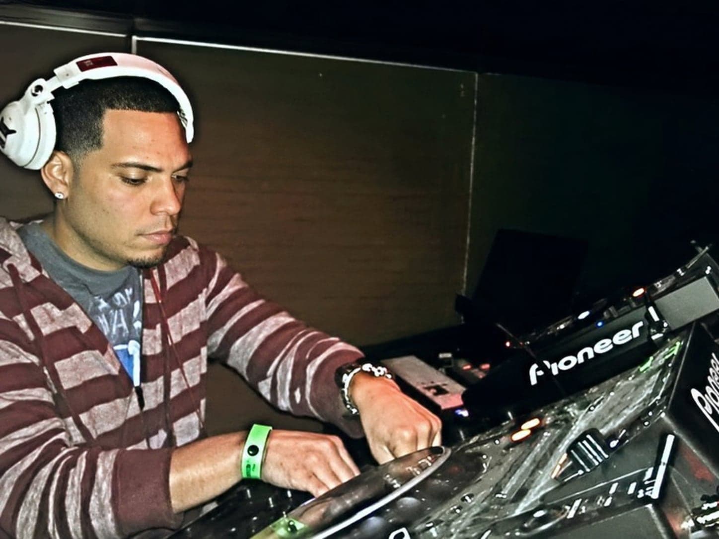 Abel J. Fernandez seated at a production console in the control room